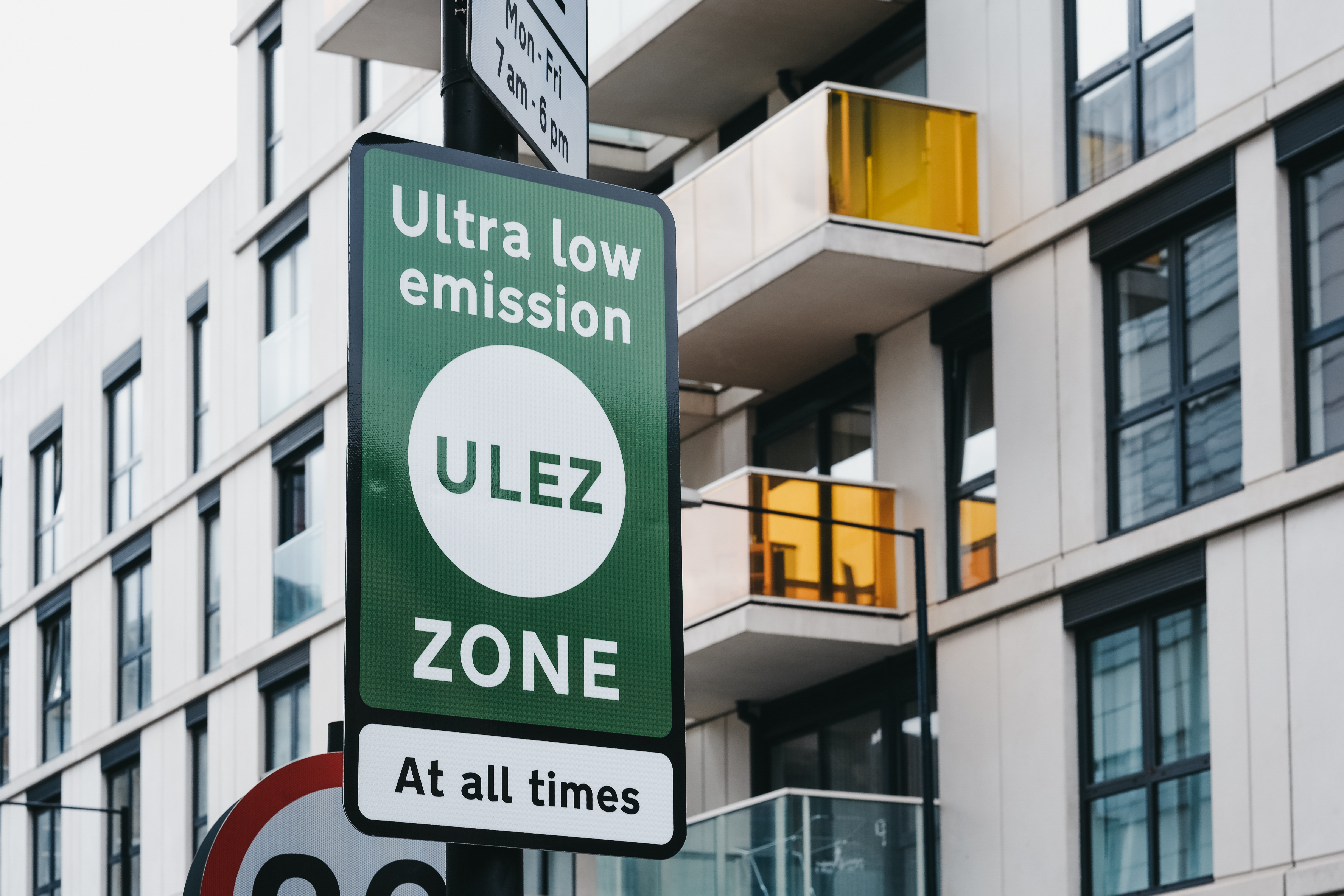 A street sign in London, England signifying that the driver is entering an ultra low emission zone and that it is enforced at all times.