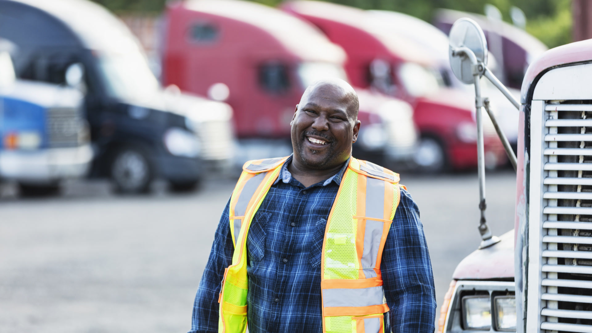 person standing in a lot full of trucks