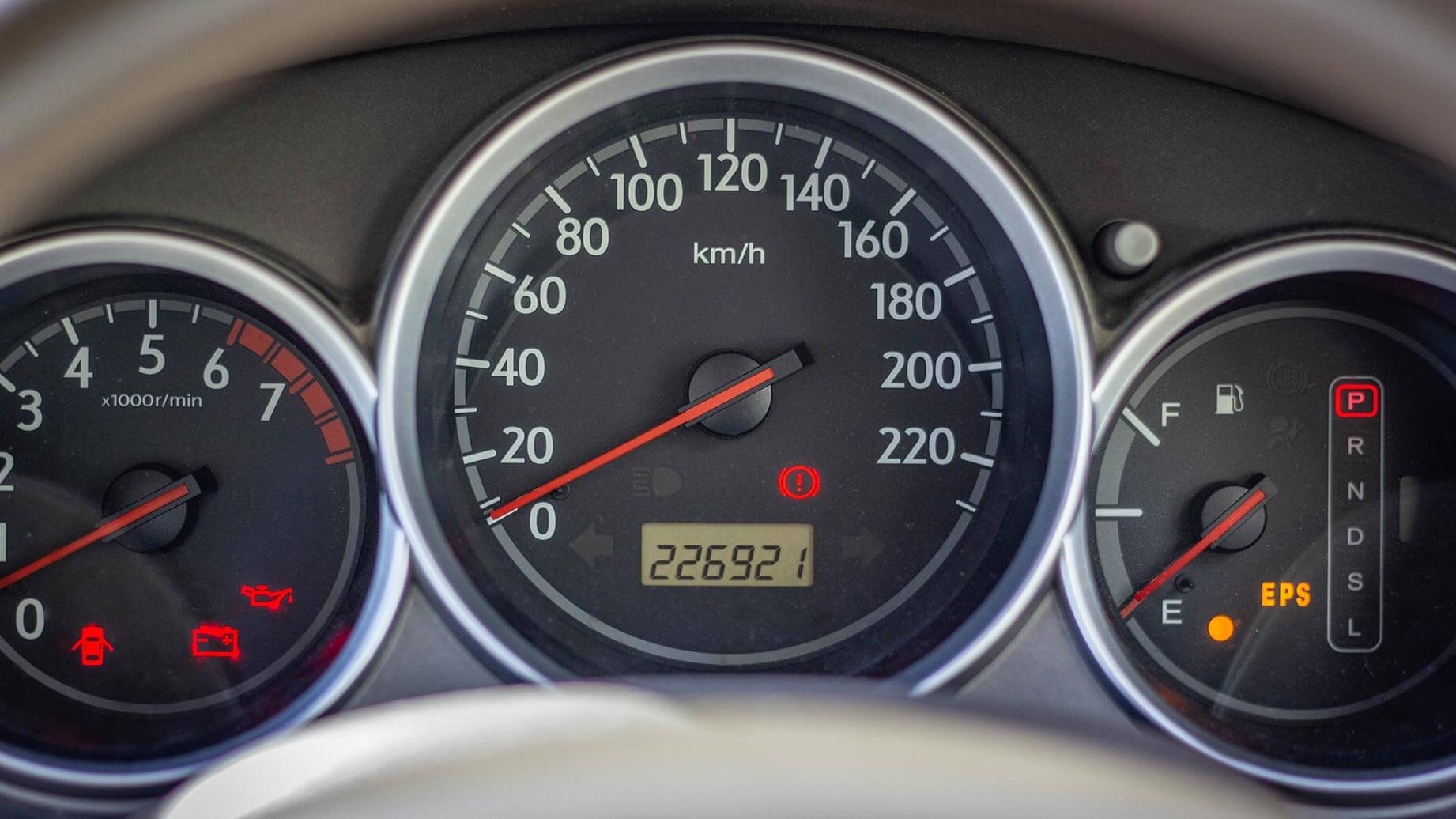 An image of an odometer with three dials.