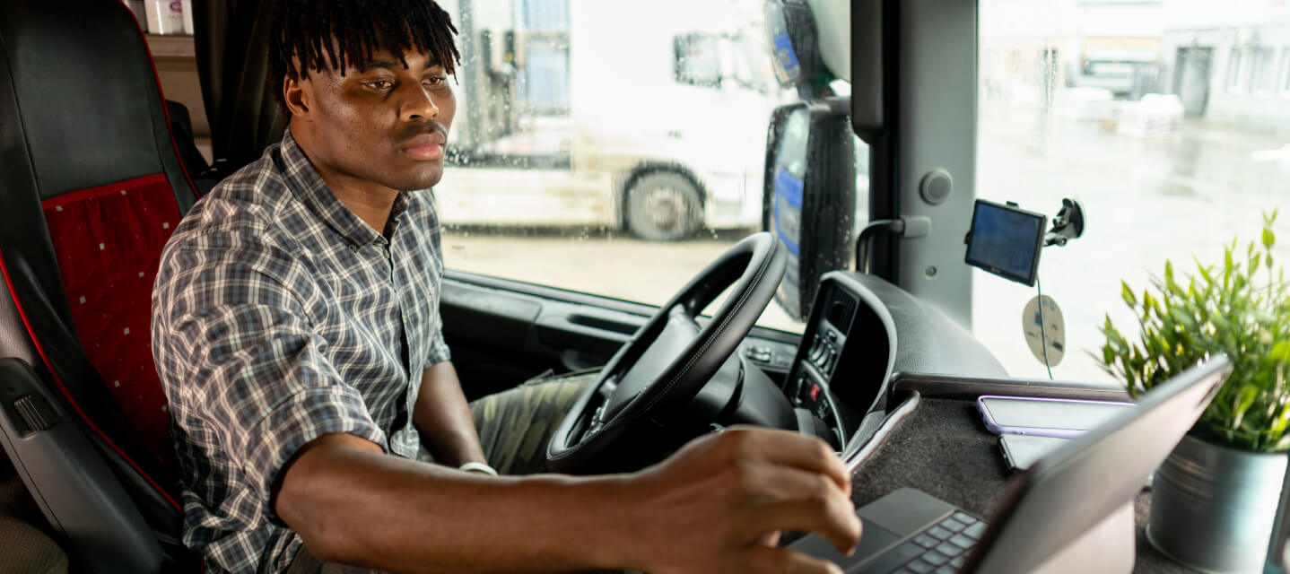 A man sitting in a fleet vehicle using the GPS tool 
