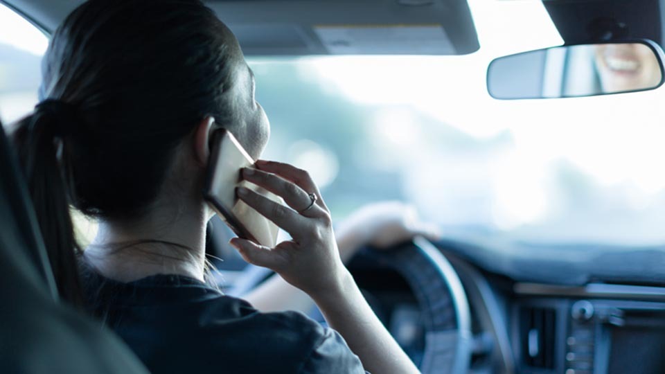 Woman distracted driving on her cell phone