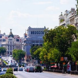European city road with cars driving down the street.