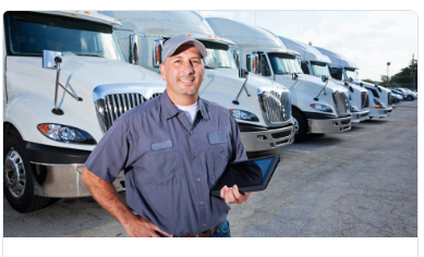 dirver infront of fleet of trucks