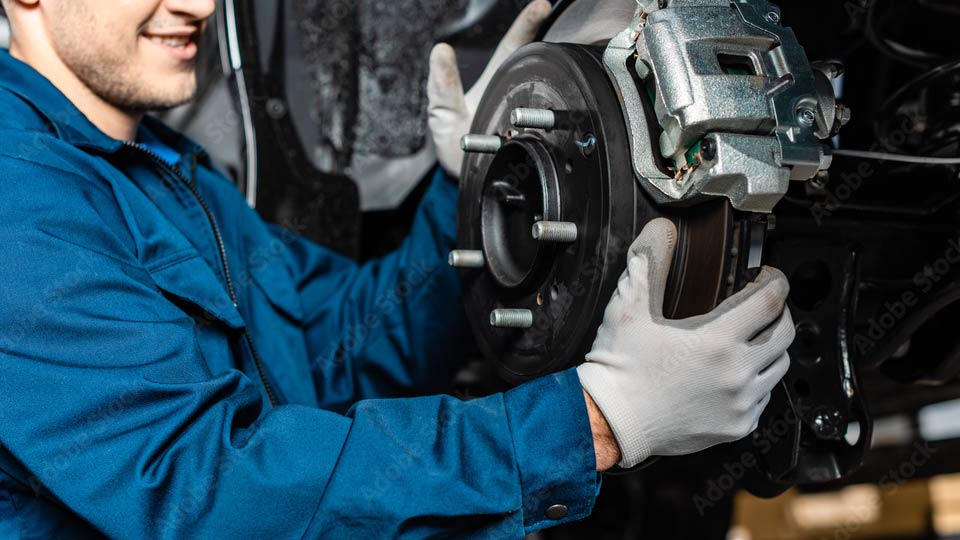 mechanic working on anti-lock brakes (ABS)