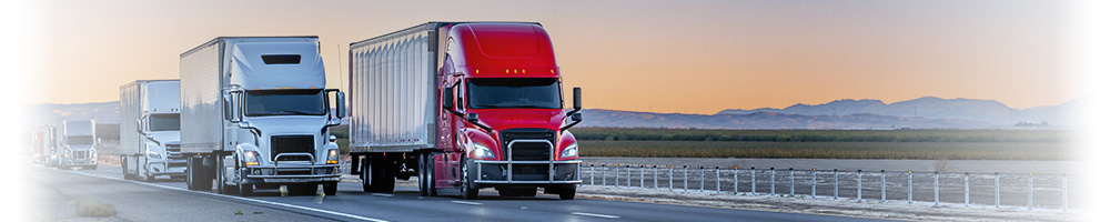 two trucks driving on the highway