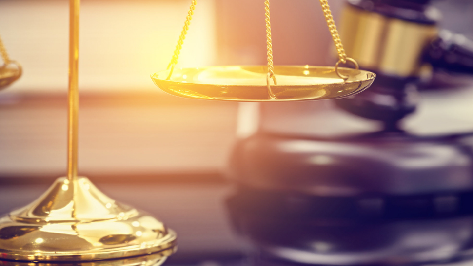 Gold scales of justice and judge gavel