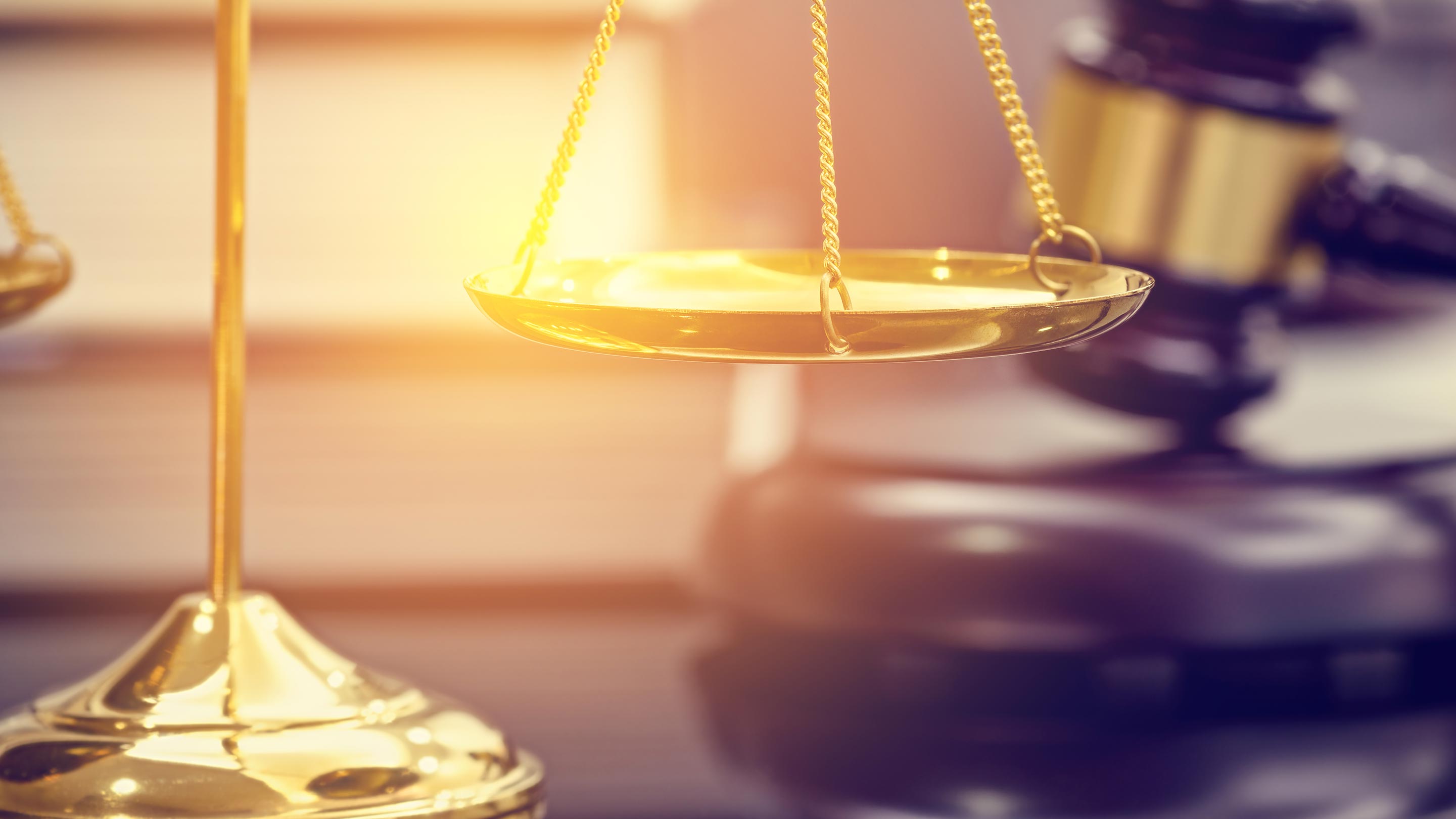 Gold scales of justice and judge gavel