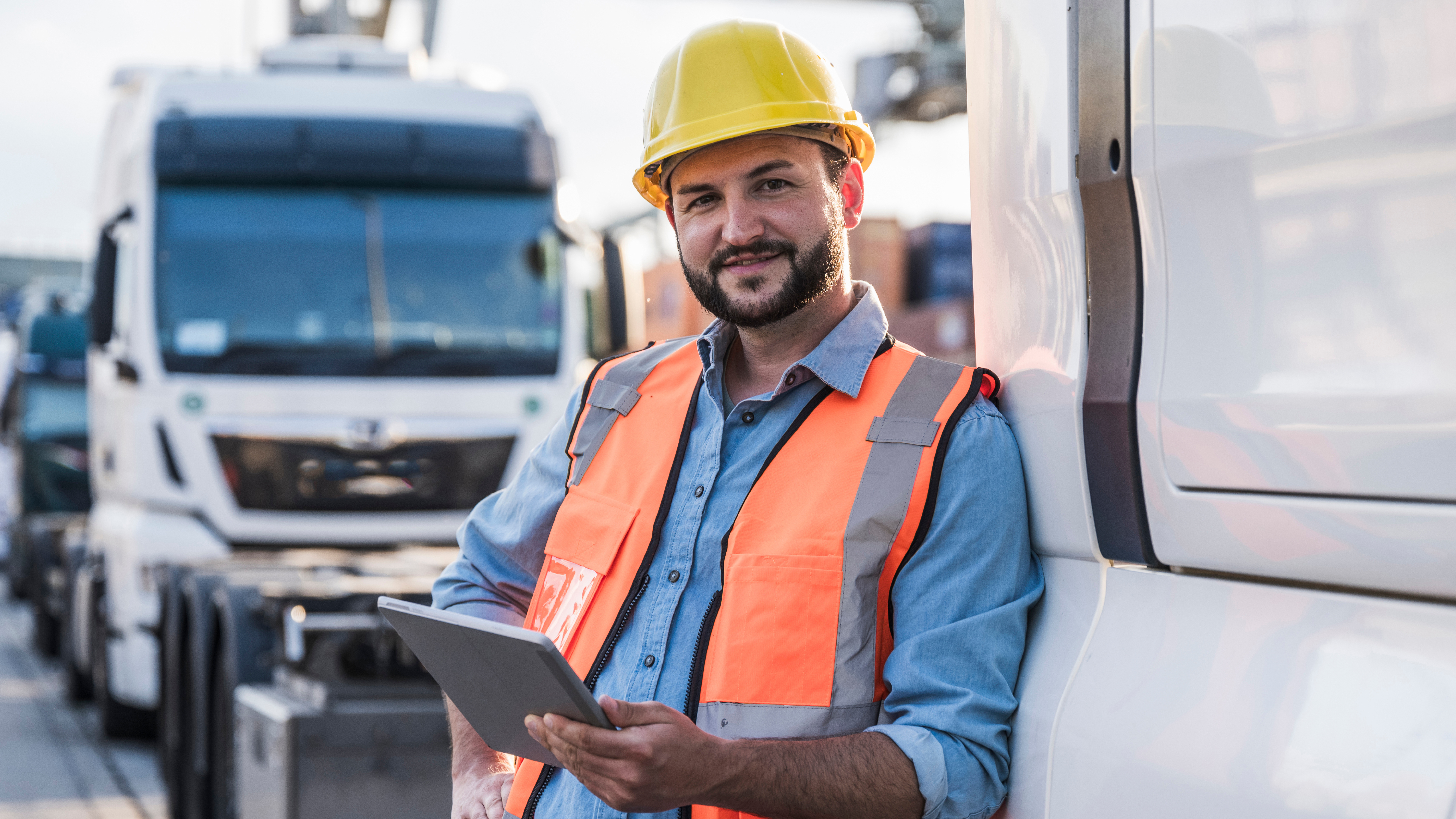Driver leaning against a truck